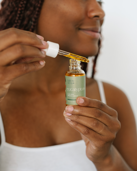 Girl holding a bottle of Tallow Vera's Aloe Vera serum