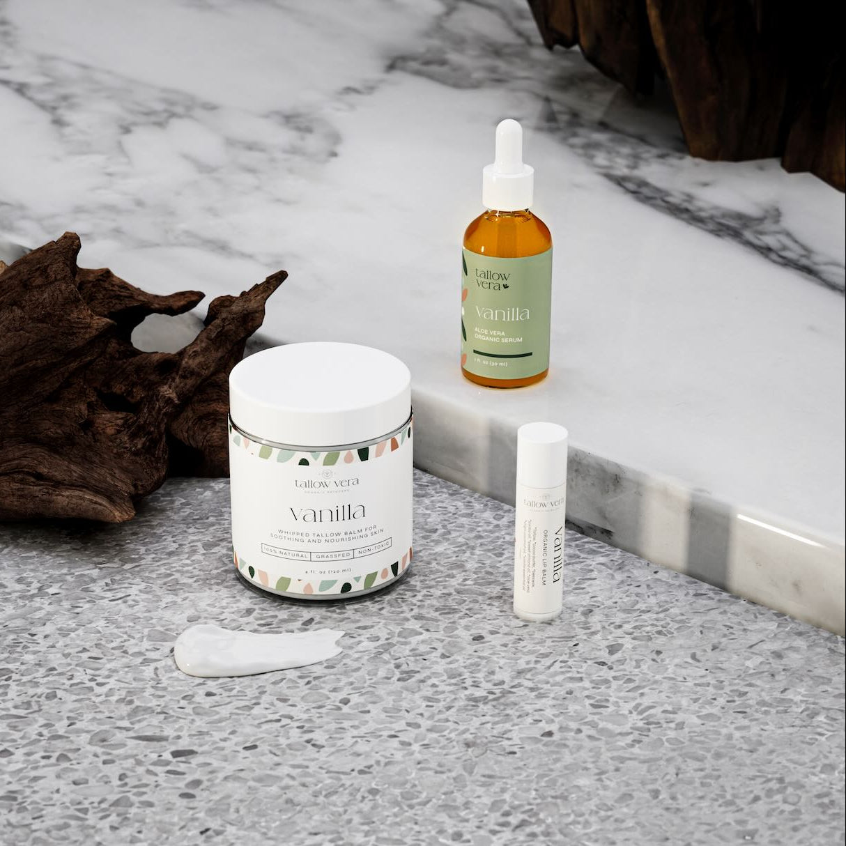 Tallow Vera's Bundle of vanilla whipped tallow balm, organic Aloe Vera serum, and organic tallow lip balm in front of decor