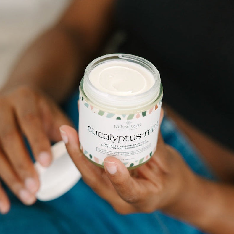 Girl holding Tallow Vera's white Eucalyptus + Mint 4oz tallow balm.