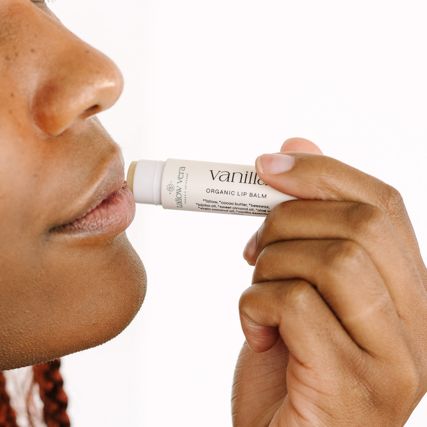 Girl applying Tallow Vera's organic vanilla tallow lip balm