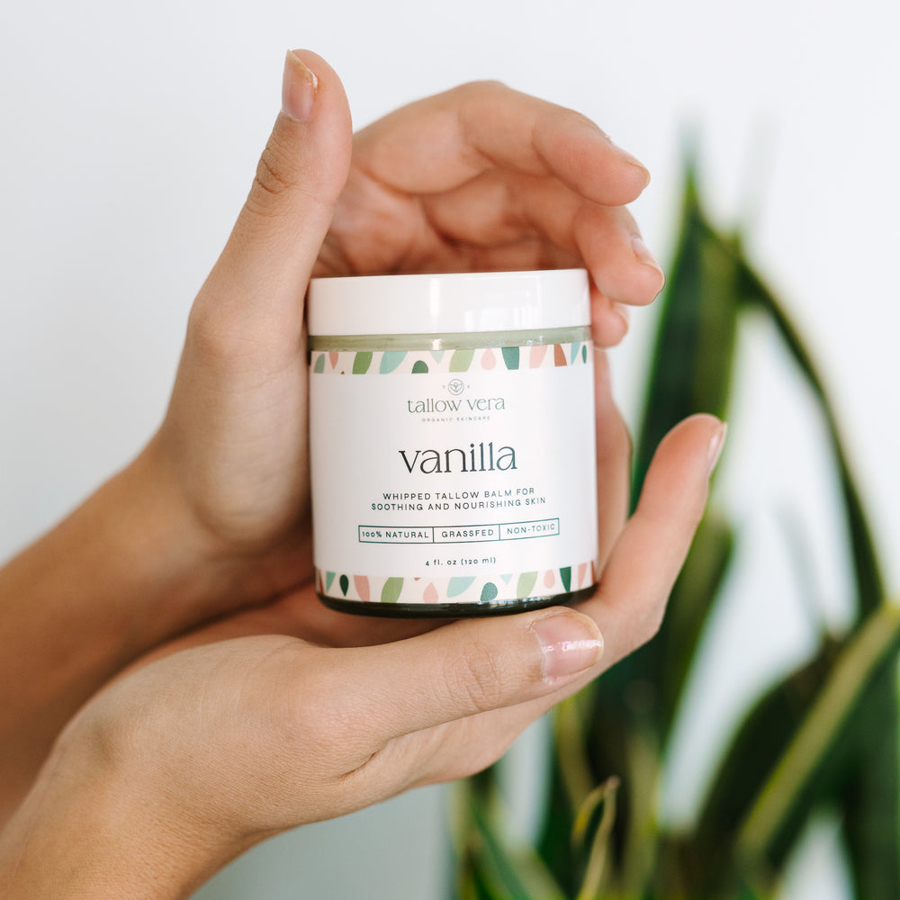 4oz vanilla whipped Tallow Vera tallow moisturizer being held by hands
