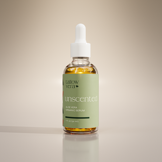 A clear glass bottle with a dropper containing yellow-colored Unscented Aloe Vera Serum, labeled with the brand 'Tallow Vera' and the product name 'Aloe Vera Organic Serum'.