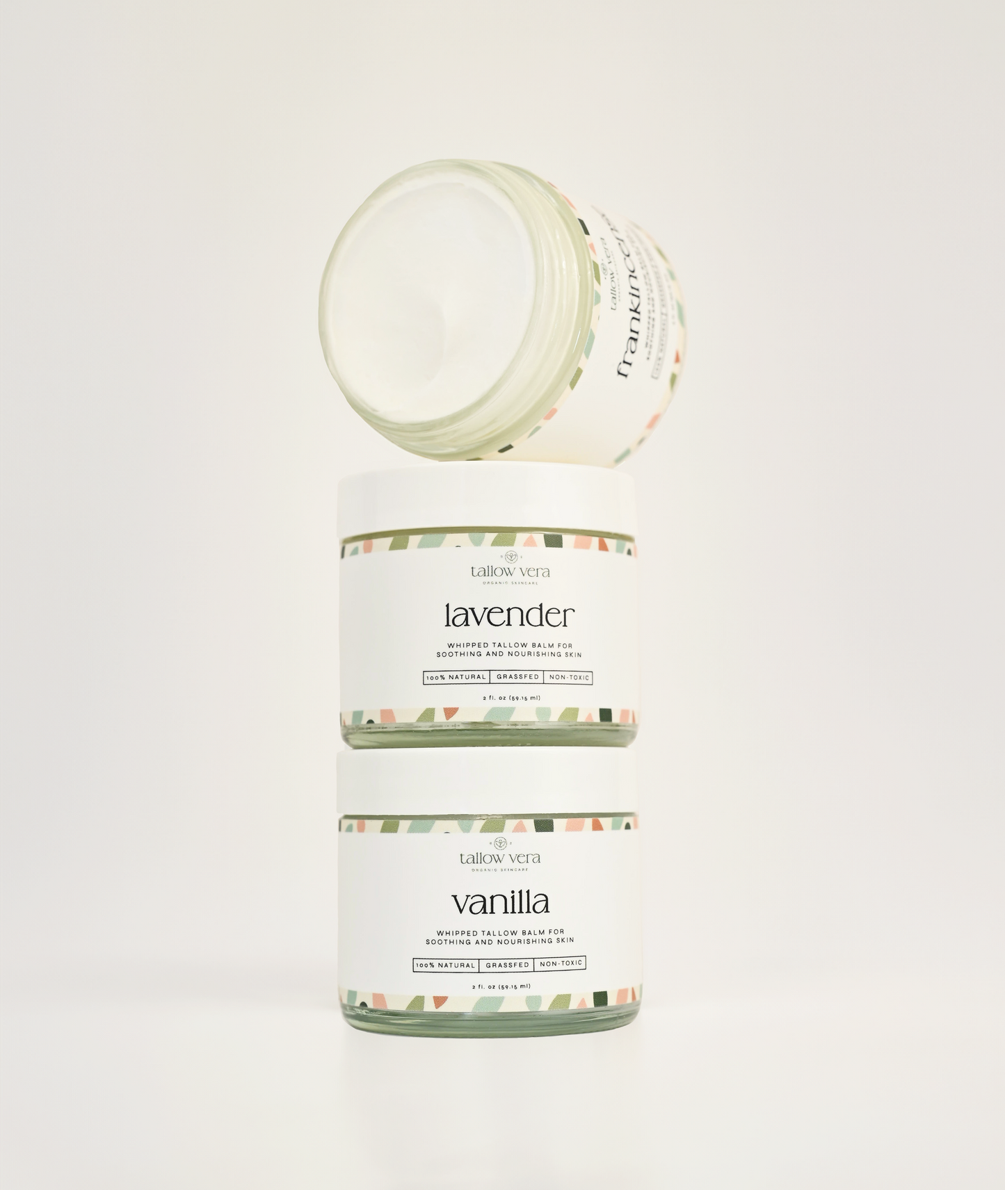 Two jars of lavender and vanilla scented tallow balms on a white background